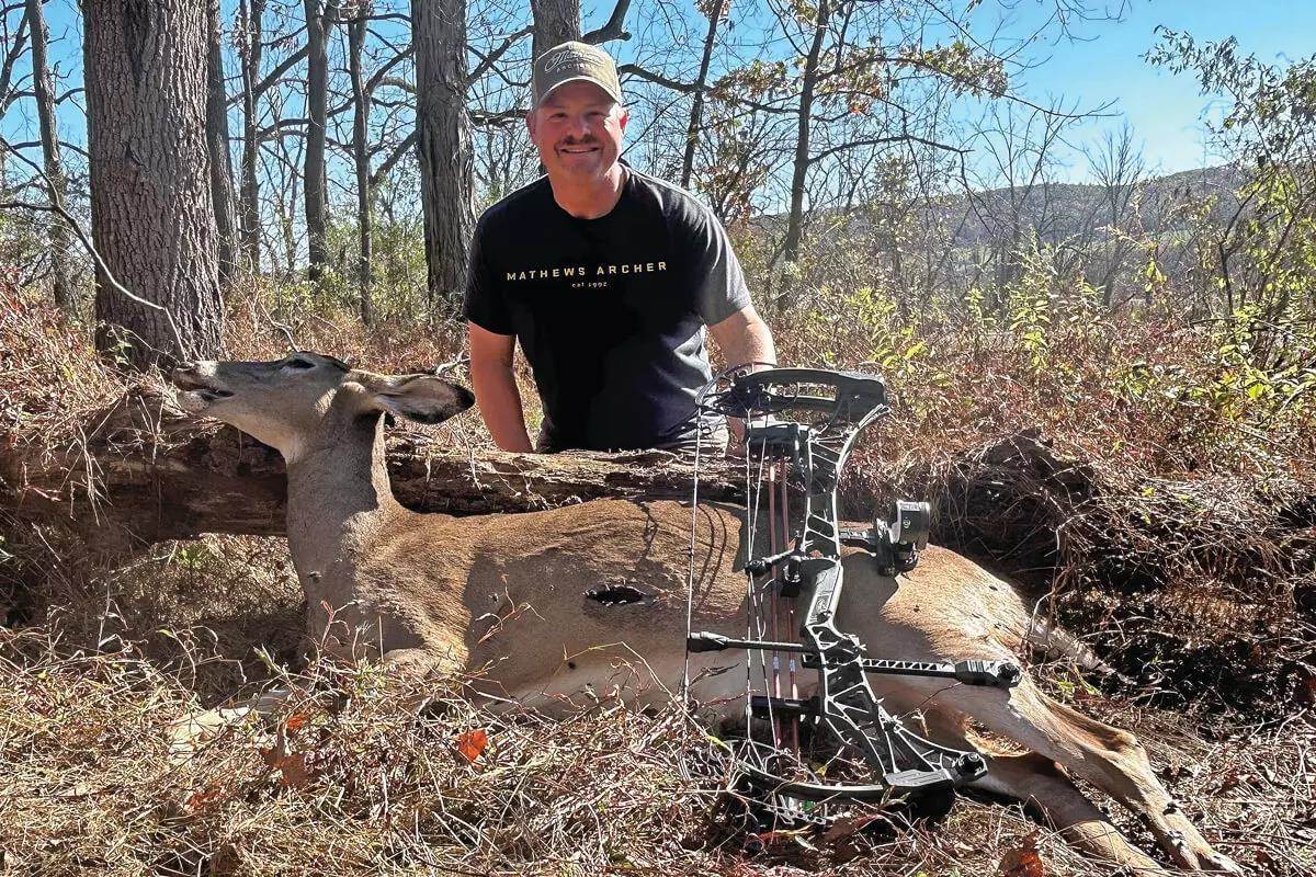bowhunter with downed Pennsylvania doe