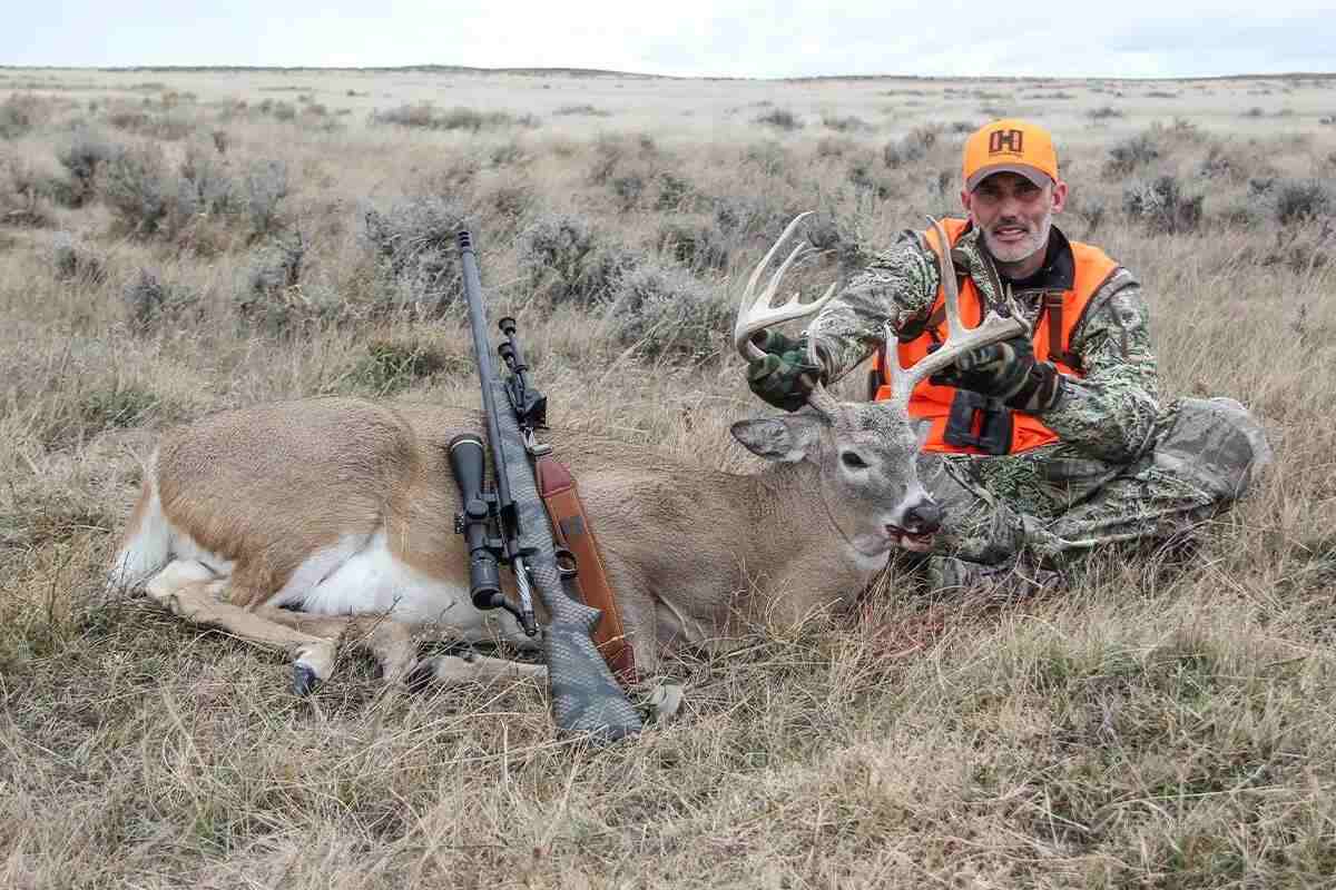 hunter with whitetail buck