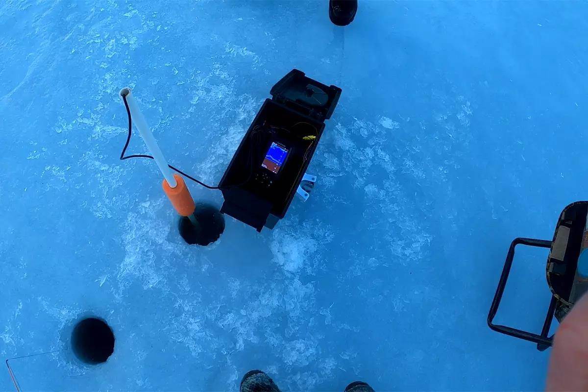 A fish finder with a transducer dropped in the ice. 