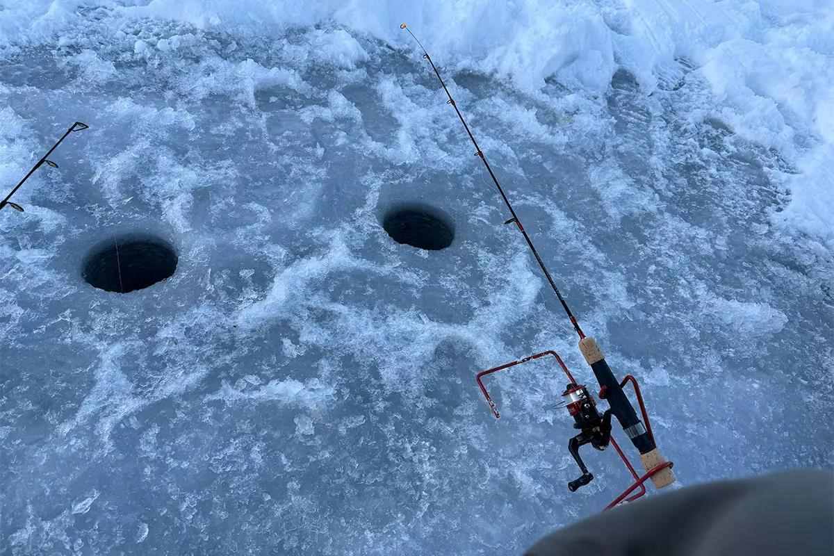 Two fishing poles are set up in a spring bobber to catch fish under the ice. 