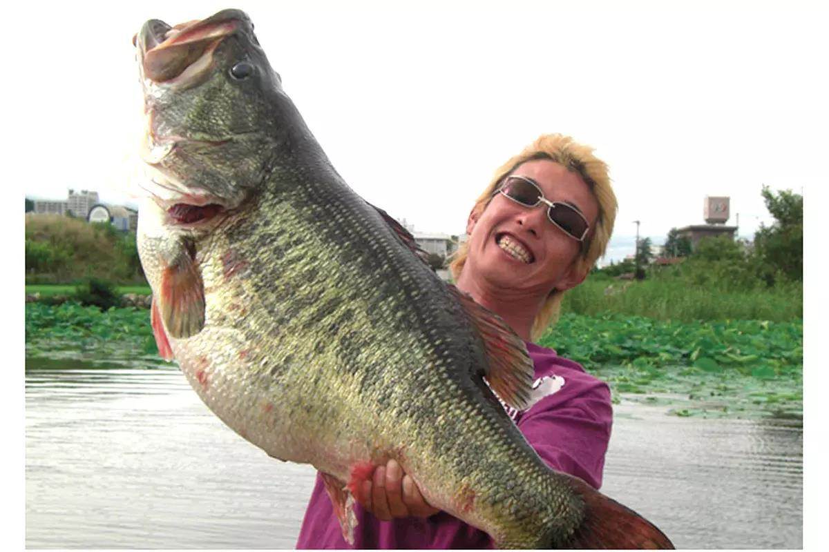 man holding world-record largemouth