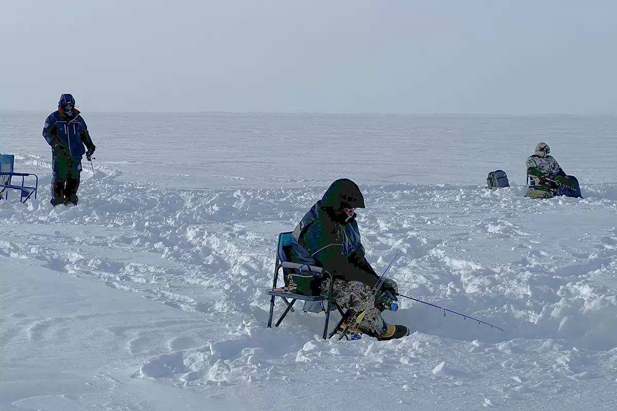 men ice fishing