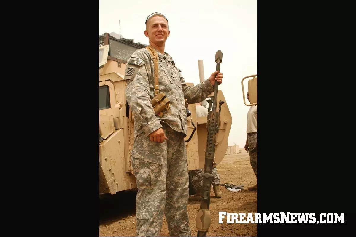 US Army soldier standing with .50 caliber rifle in Iraq.