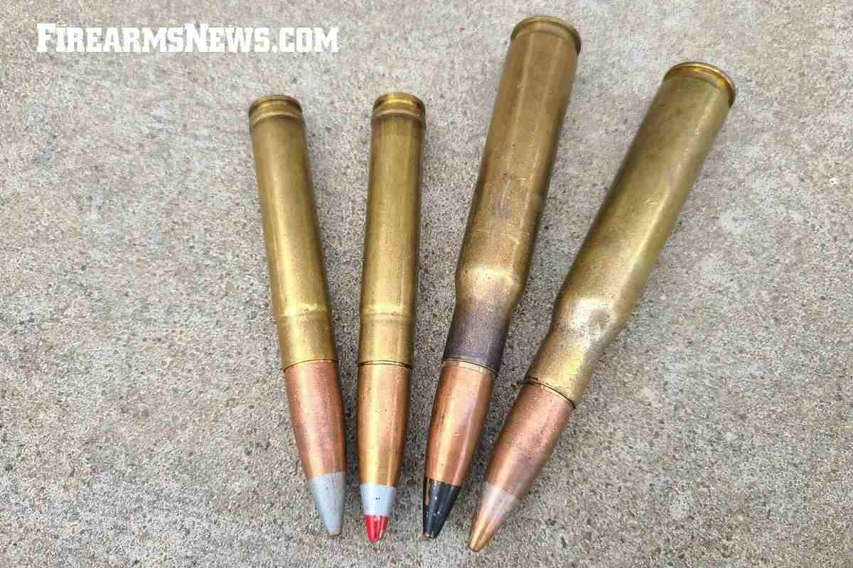 Four large rifle cartridges lying next to each other showing their sizes.