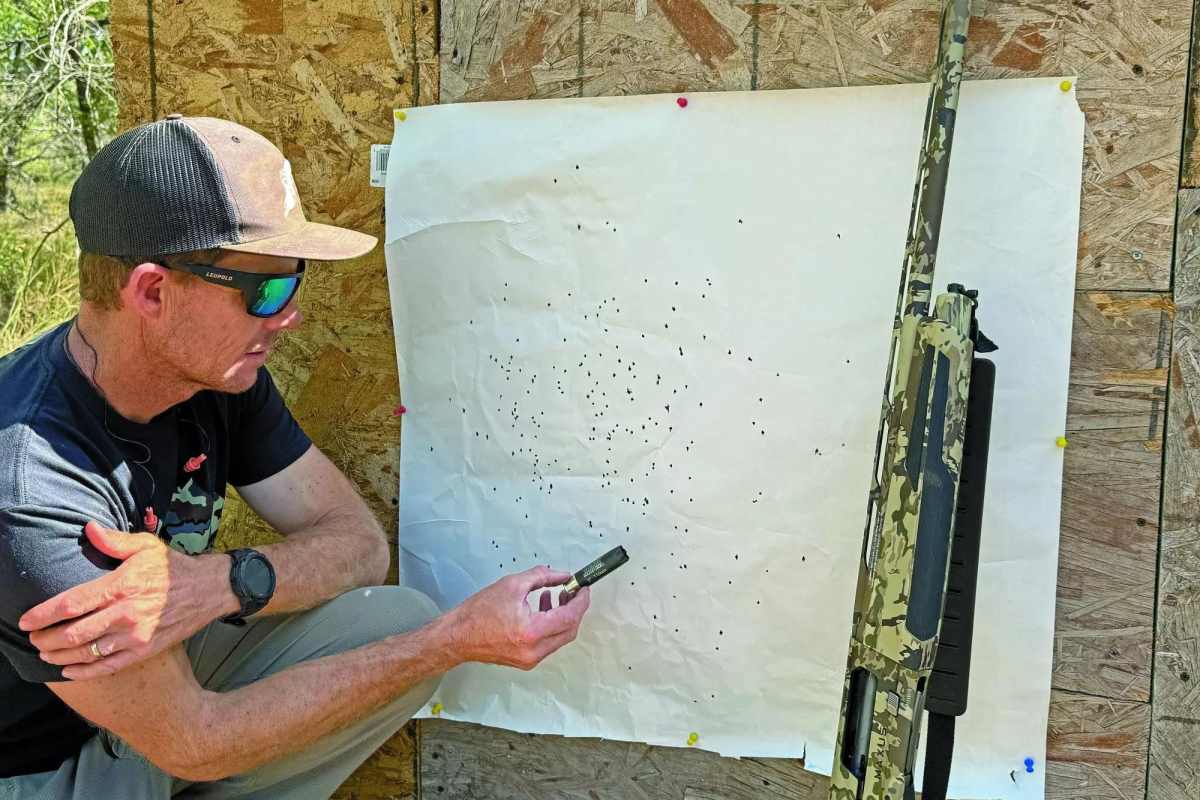 The author next to a patterning sheet showing how well the shot shells performed.