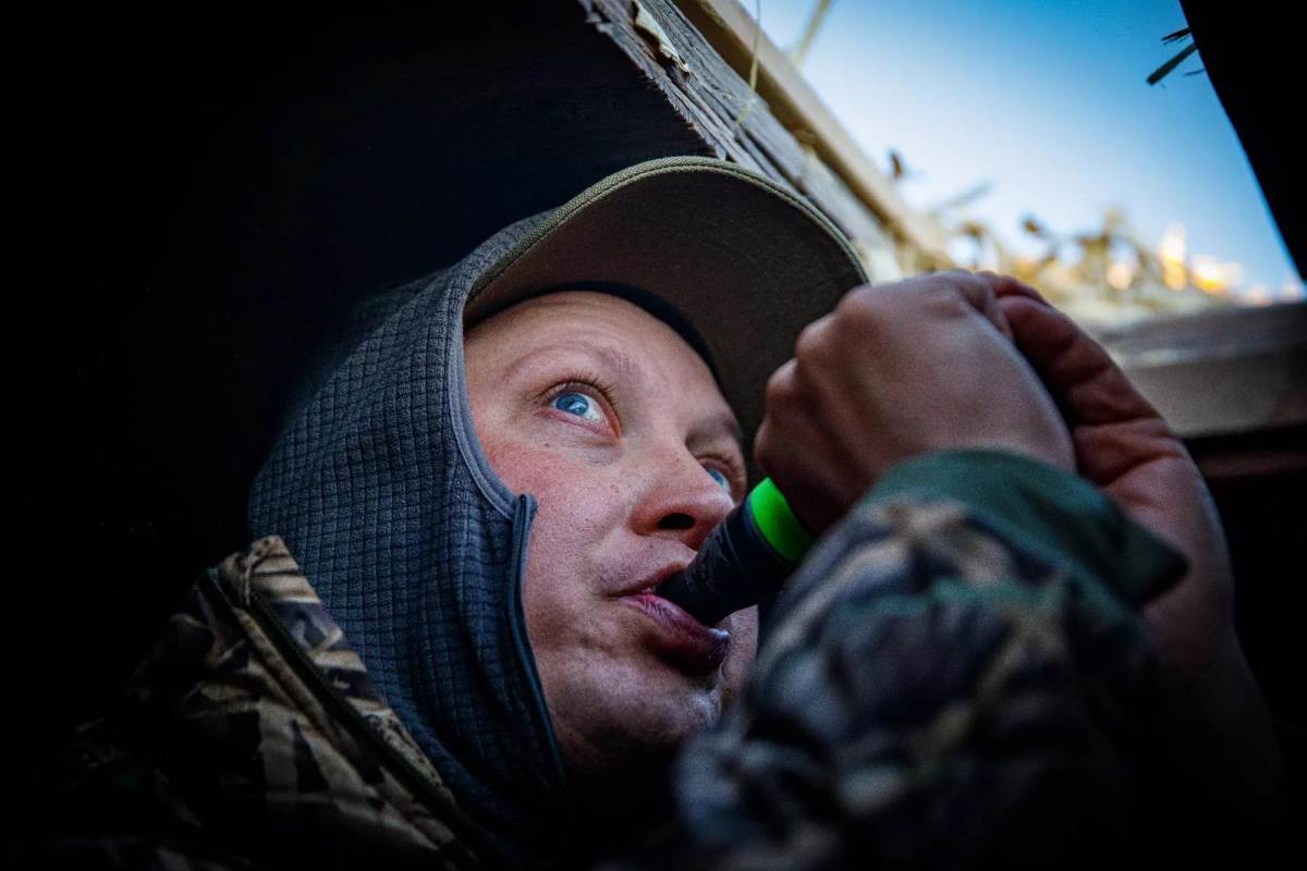 A hunter blowing a call.