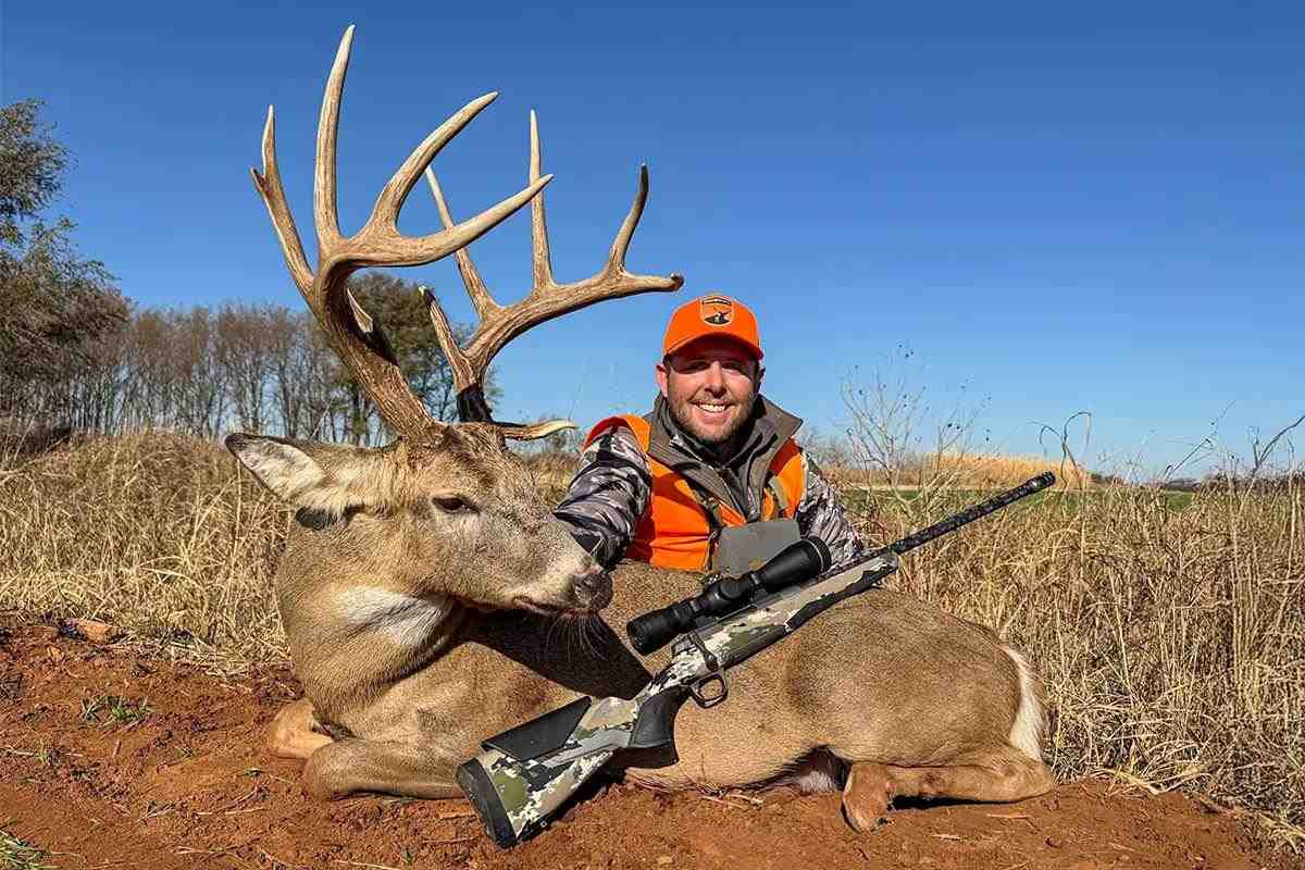 hunter with whitetail buck