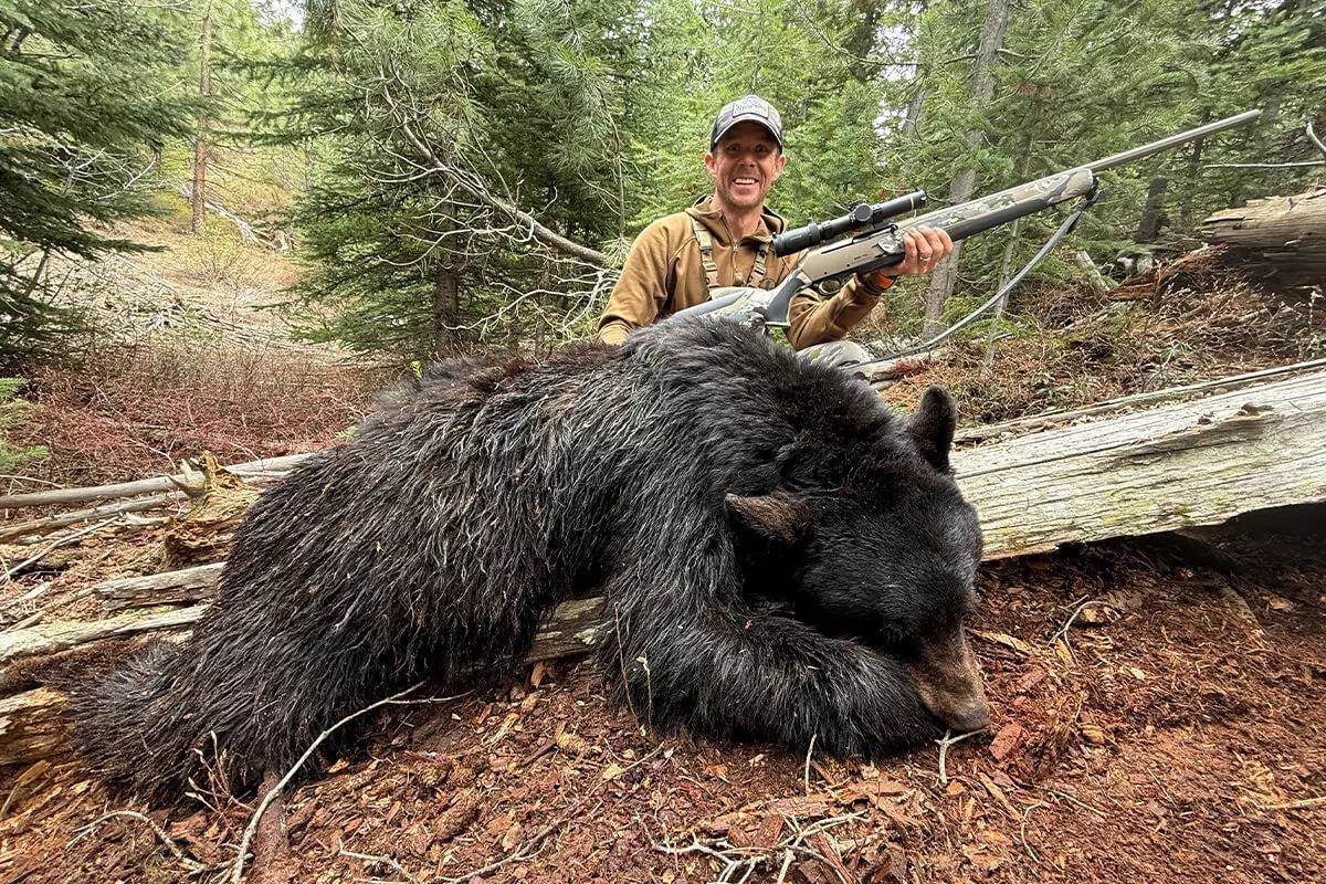 hunter with dead bear
