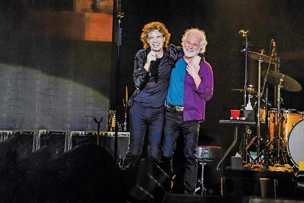 Chuck Leavell and Mick Jagger on stage.