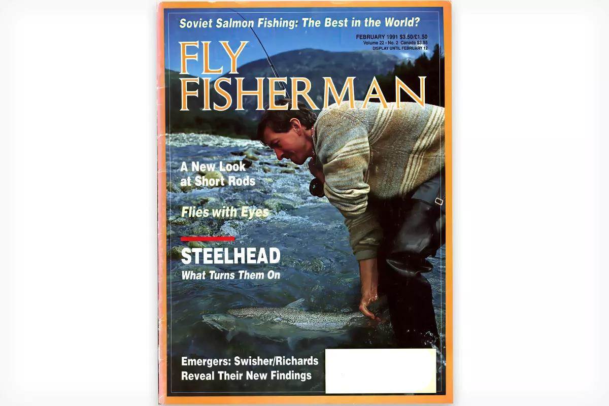 Vintage Fly Fisherman magazine cover showing an angler handling a steelhead in a river.