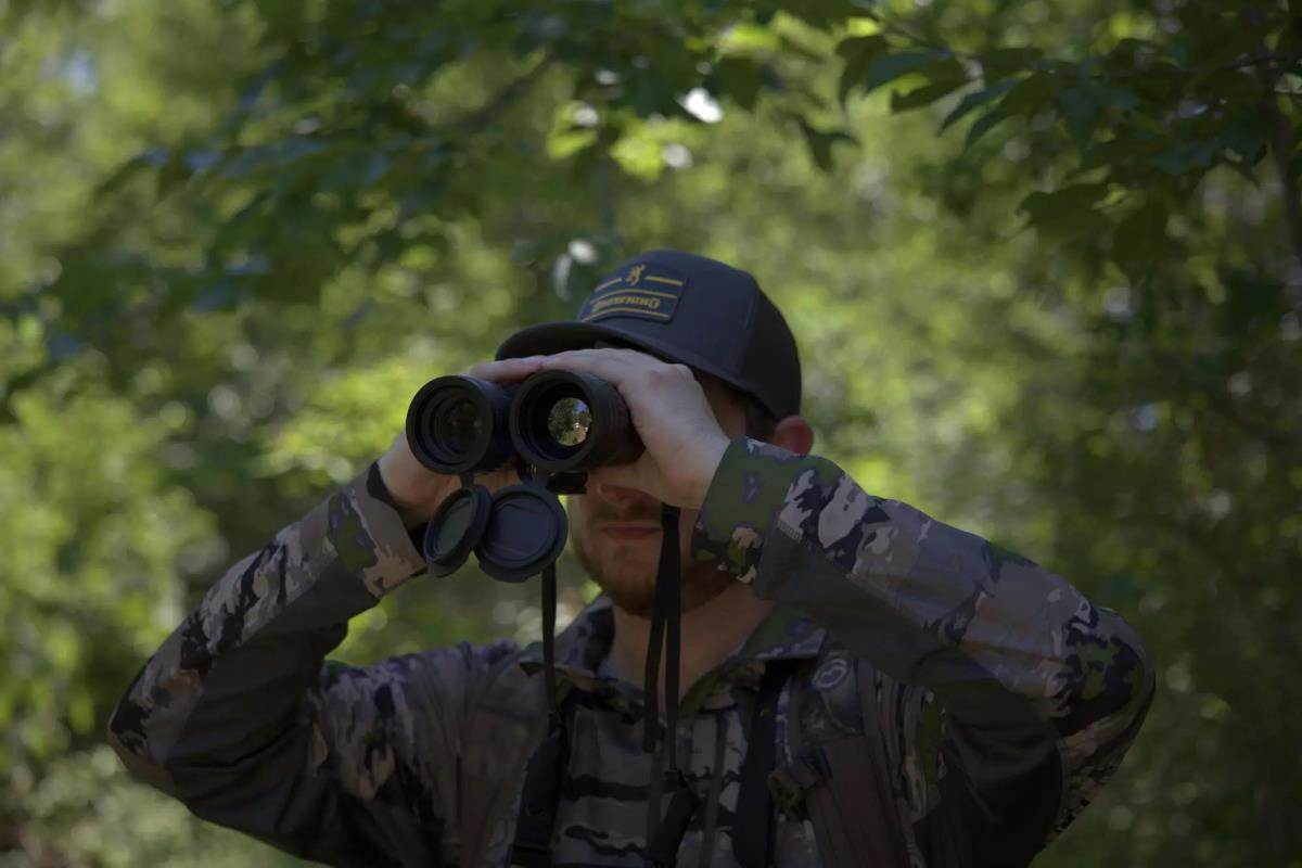 man glassing with binoculars