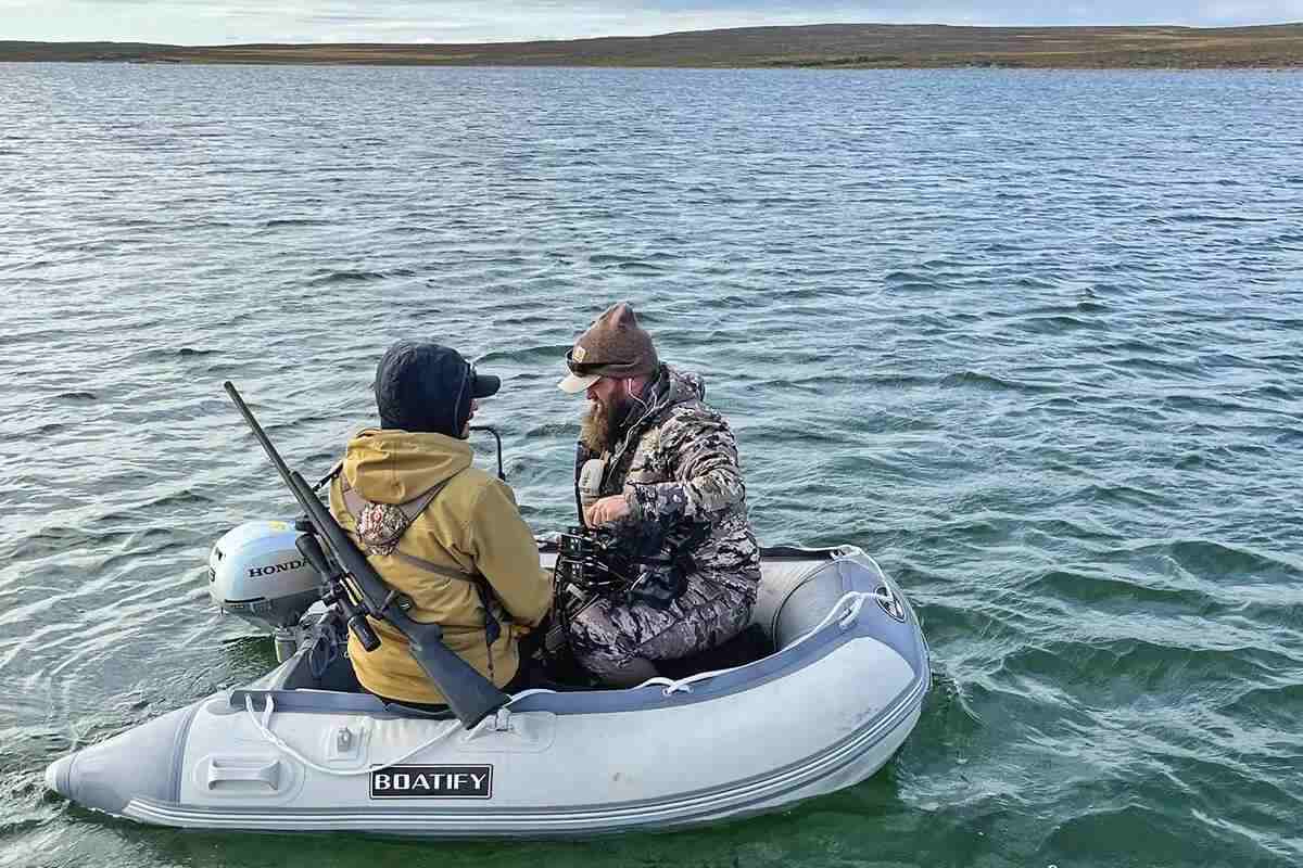 two men in small raft on water