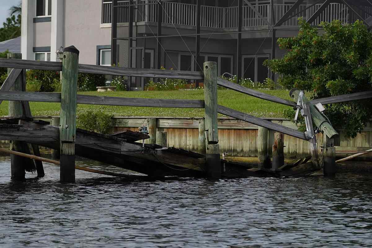 destroyed fishing dock in front of residential apartments