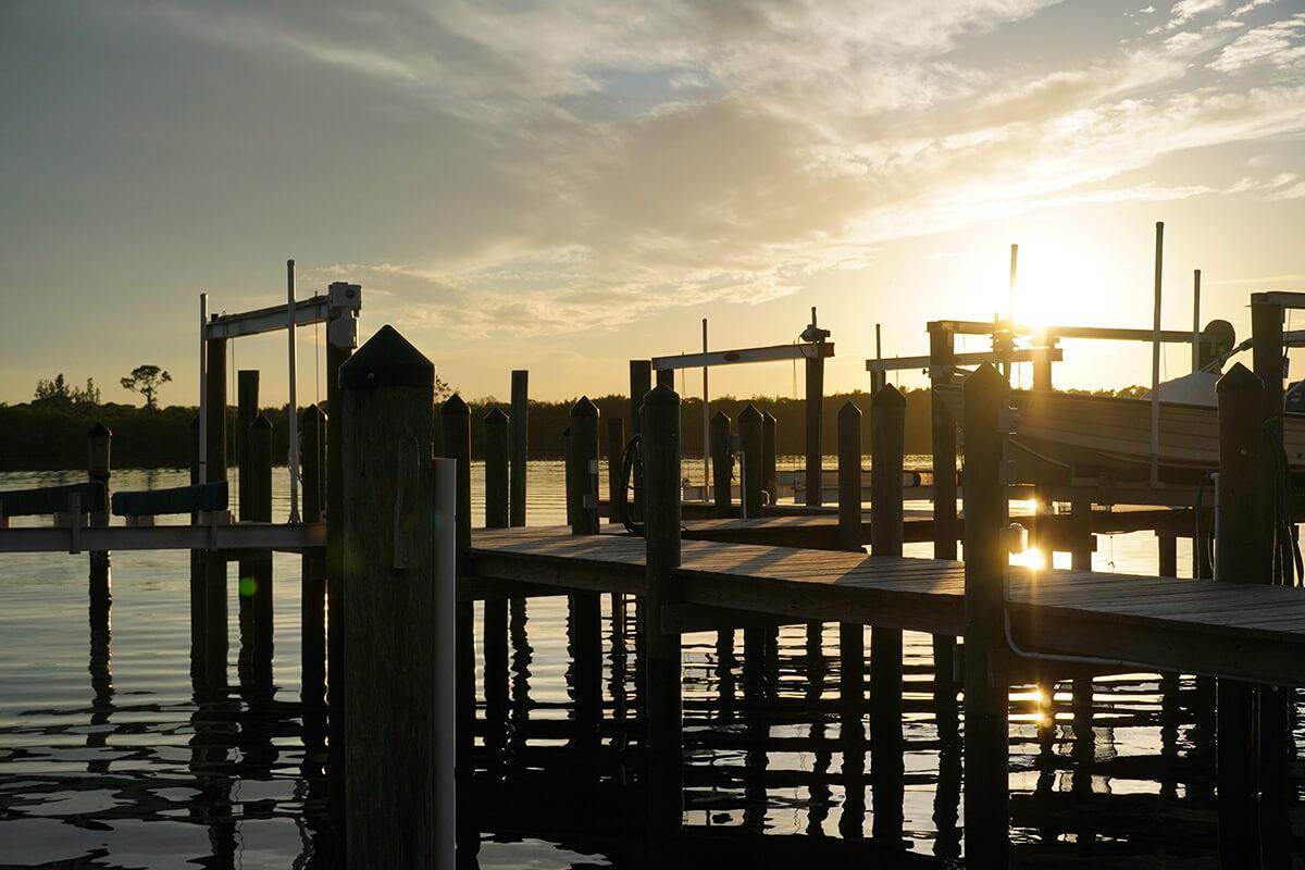 saltwater fishing dock with sun in the background