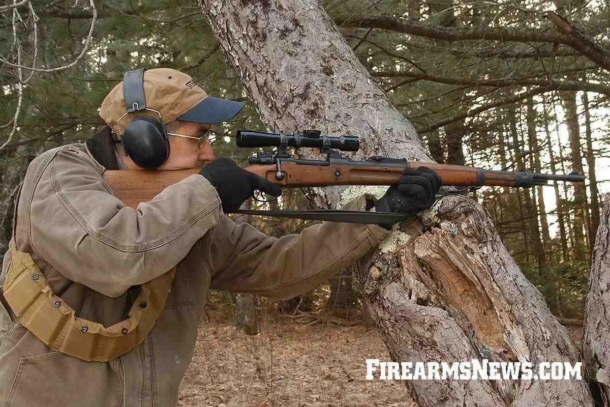 Rifleman with scoped Mauser Kar 98k rifle firing supported off a tree.