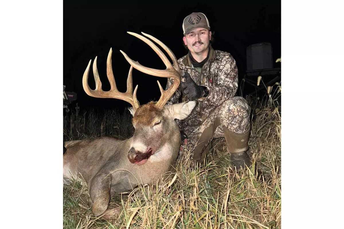bowhunter with downed Kansas target whitetail