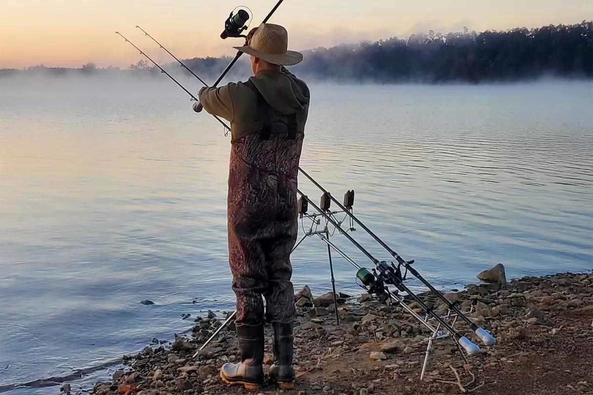 An angler casts a bait into a lake.