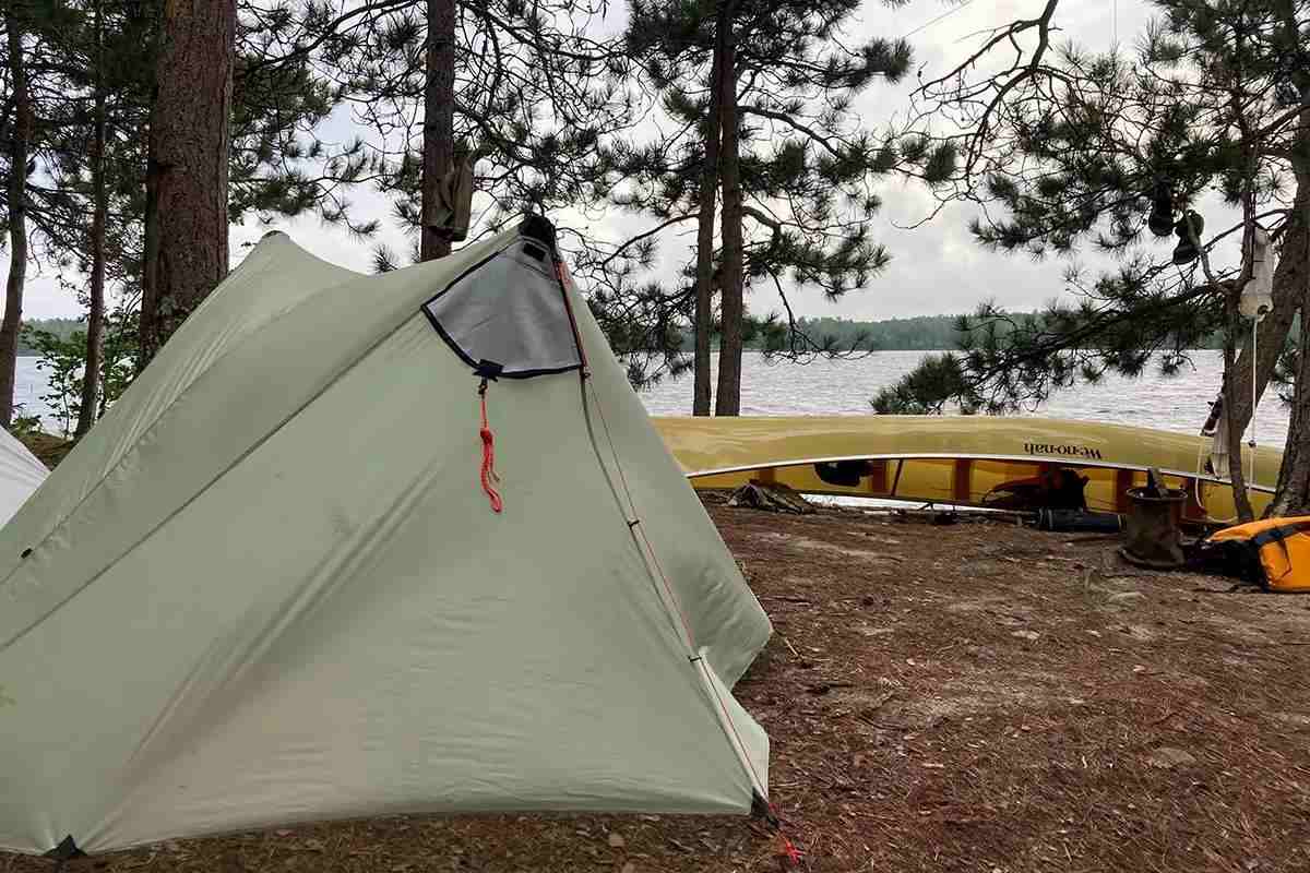 A Boundary Waters campsite with a tent and a yellow canoe. 