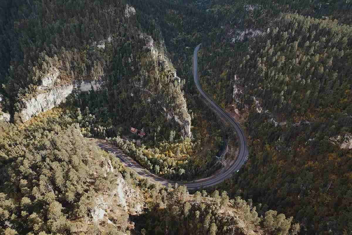 A drone photo of a meandering road in the Black Hills of South Dakota. 