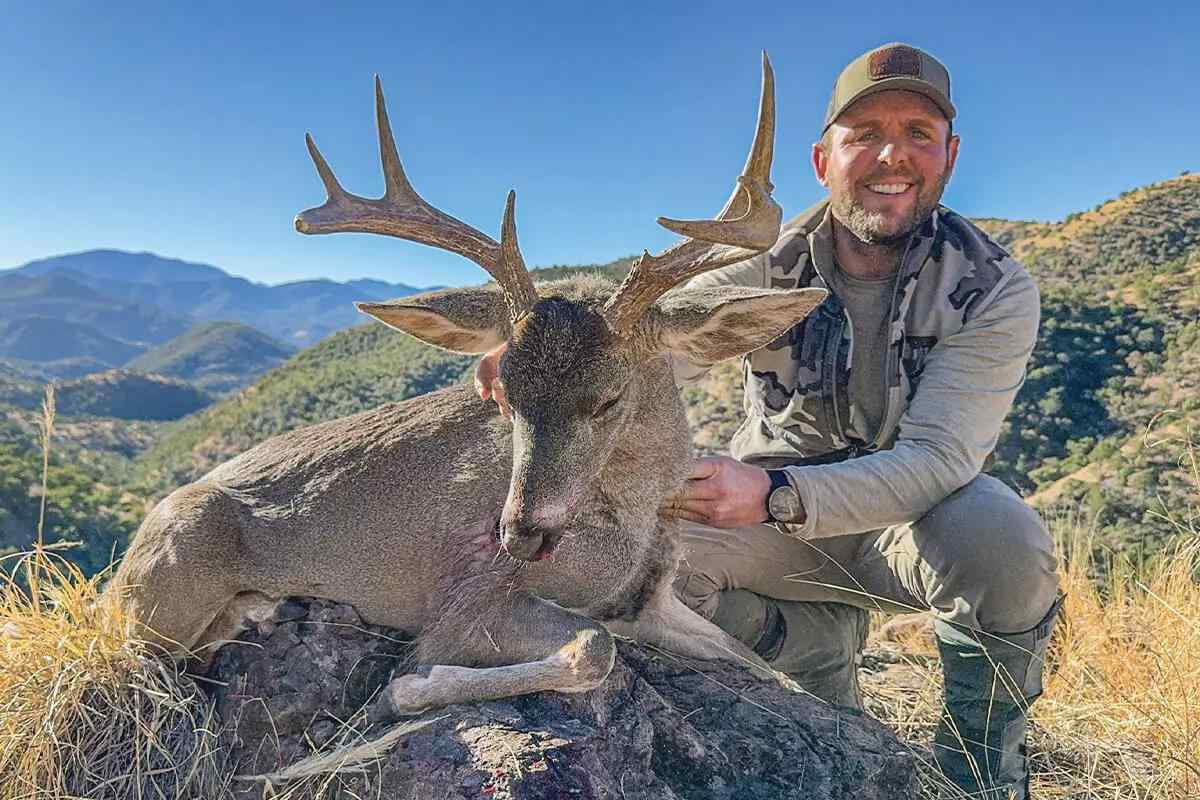 hunter with coues buck