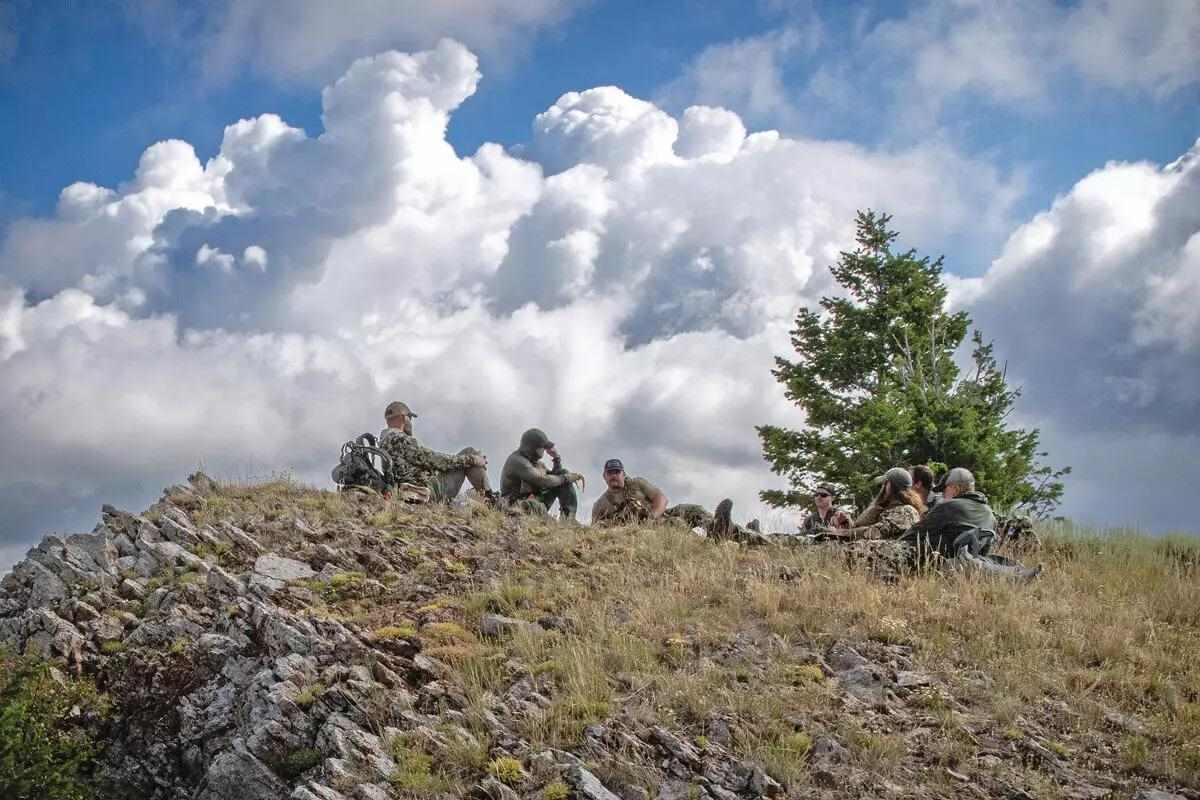warriors sitting on top of hill in the outdoors