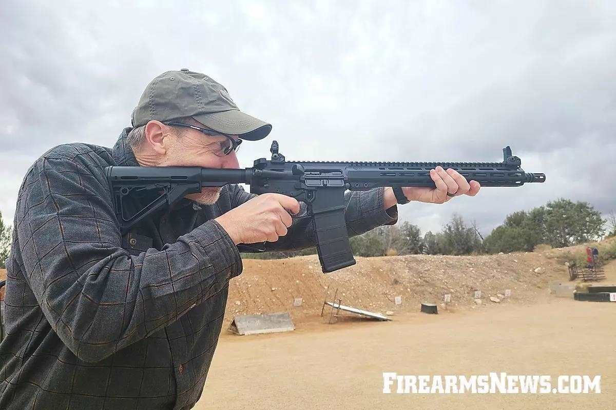 Man shooting rifle offhand