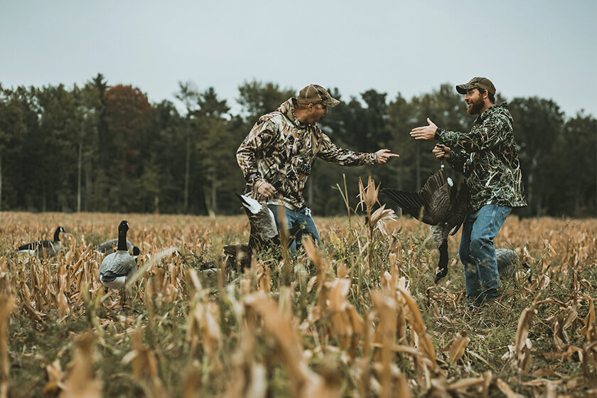 Goose hunters celebrating a volley