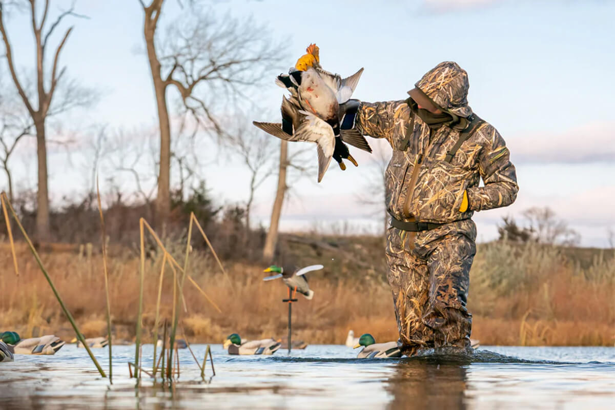 duck hunter standing in flooded timber