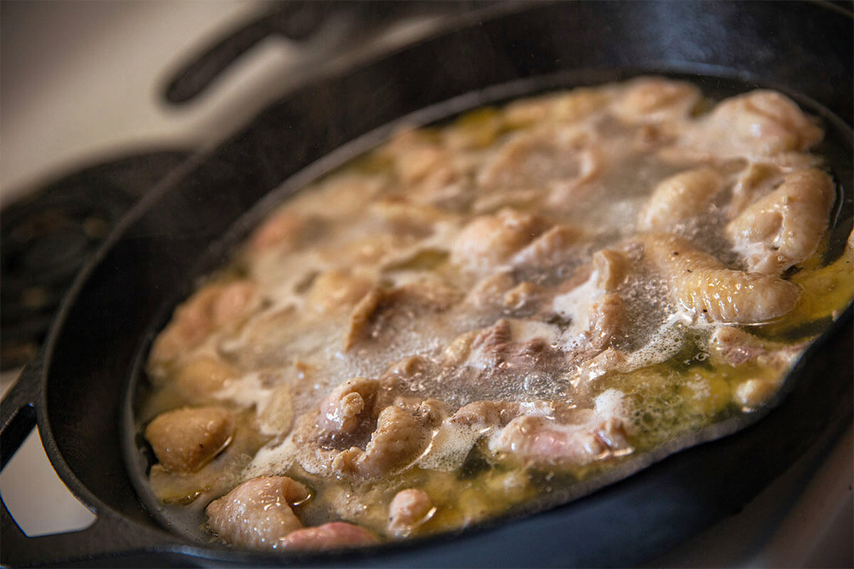 cooking waterfowl in pan on stove