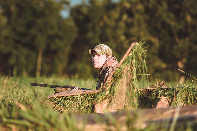 Goose hunters in layout blind