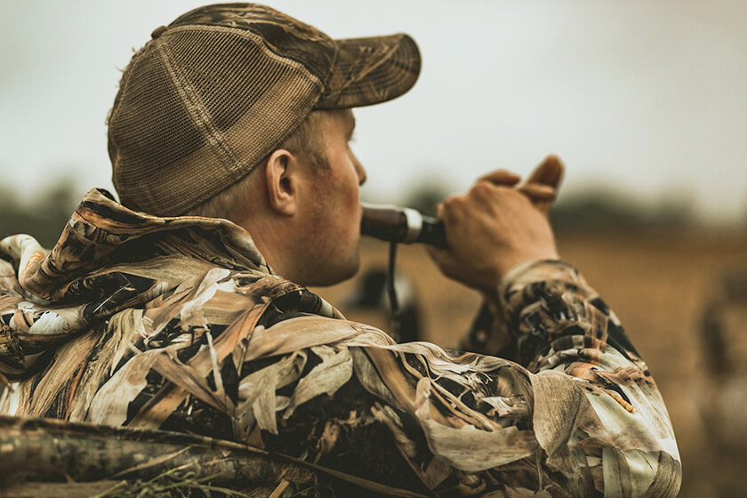 Goose hunter on a goose call